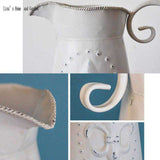 broc eau métal décoration fleur de lys