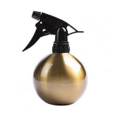 pequeña botella de spray dorada